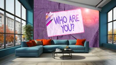 Text sign showing Who Are You Question. Business photo text asking about someone identity or demonstratingal information Writing equipment and white note paper inside pocket of man work trousers Wall mural