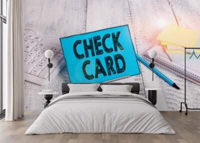 Word writing text Check Card. Business photo showcasing allows an account holder to access funds in her account Notepaper stand on buffer wire in between computer keyboard and math sheets Wall mural