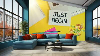 Writing note showing Just Begin. Business concept for to start to happen Begin to do something in business or a job Laptop marker squared sheet spiral notebook envelope colored background Wall mural