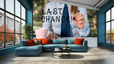 Writing note showing Last Chance. Business concept for final opportunity to achieve or acquire something you want Female business person sitting by table and holding mobile phone Wall mural