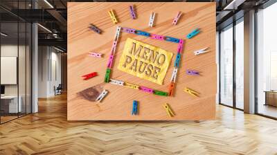 Writing note showing Meno Pause. Business concept for the process through which a ceases to be fertile or menstruate Colored clothespin papers empty reminder wooden floor background office Wall mural