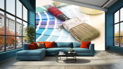 Color palette guide and painting supplies, paint brushes and color cans on wooden background Wall mural