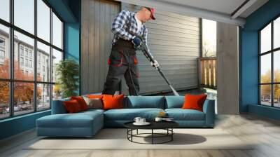 man is cleaning terrace with a high temperature pressure cleaner on concrete terrace floor Wall mural