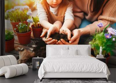 Mother and her child planting seeds together in their backyard garden, hands dirty with soil, excited to watch the flowers grow , woman and kid Spring Garden Planting concept image Wall mural