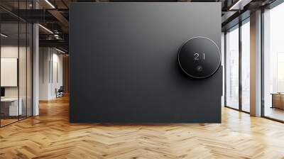 A modern, smart thermostat set to 21 degrees on a dark wall Wall mural