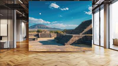 Ancient stepped pyramids with mountain in background under bright blue sky Wall mural