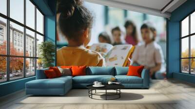 Child reading a book to classmates in school Wall mural