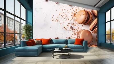 Chocolate macarons with pieces of chocolate and sprinkles on white surface Wall mural