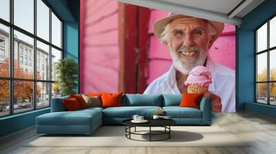 Elderly white man enjoying ice cream cone, pink wall in background Wall mural