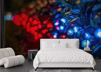 Festive lights in red and blue bokeh effect with greenery, blurred background Wall mural