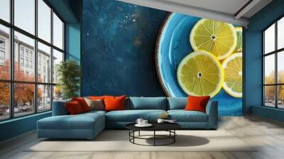 Fresh lemon slices on blue ceramic plate beside dark textured background Wall mural