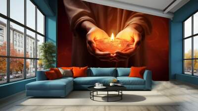 Man holds candle in his open palms. Charity, donate, pray concept Wall mural