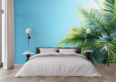 Palm tree fronds against bright blue sky Wall mural