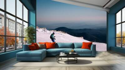 Panoramic view over the ski slope Poiana Brasov ski resort in Transylvania, Pine forest covered in snow on winter season,Mountain landscape in winter with the Bucegi Mountains in the background. Wall mural