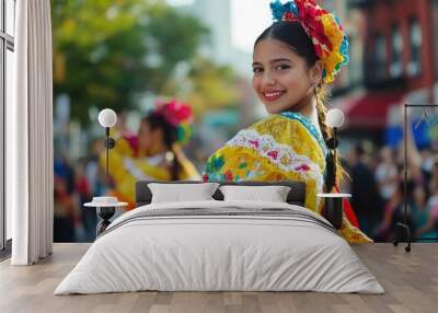 Smiling Latin female in colorful traditional dress at vibrant outdoor celebration Wall mural