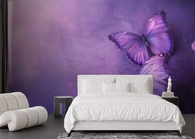 Two purple butterflies on textured violet background with soft focus Wall mural