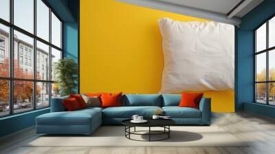 White pillow on bright yellow background, minimalistic home decor concept Wall mural