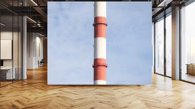 Tall, thin Two Color red and white chimney on the background of blue sky with clouds. Wall mural