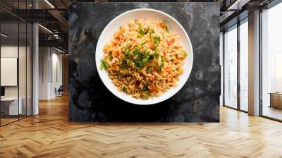 Schezwan Fried Rice Masala is a popular indo-chinese food served in a plate or bowl with chopsticks. selective focus Wall mural