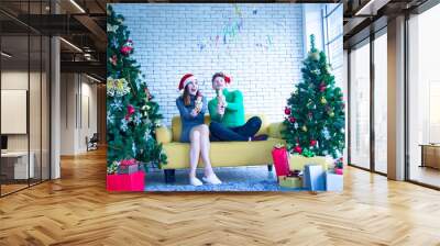 Merry Christmas and New Year concept. Young Caucasian lover with christmas theme clothing celebrate and exchange presents each other in the party with fun and happiness Wall mural