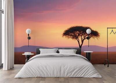 Lions resting beneath an acacia tree in the savanna at sunset, with a colorful sky creating a peaceful and expansive landscape. Wall mural