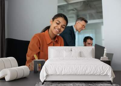 Group of diverse business people using laptop computers working together in office. Teamwork, meeting, successful business concept. African American manager taking notes planning start up at workplace Wall mural