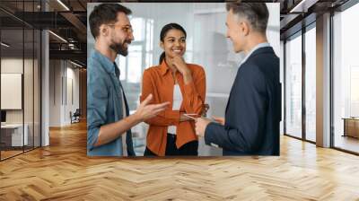 Group of multiracial business people talking, discussion start up project, brainstorming at workplace. Creative colleagues working together in modern office. Teamwork concept  Wall mural