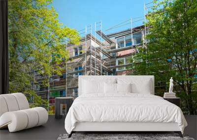 Modern residential apartment building under construction. Reconstruction of a building. Summer day. Wall mural