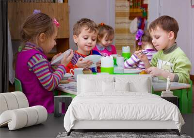 girls and boys eat at the table Wall mural