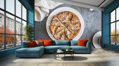 Pie with apples and curd on a white plate on a stone stove close-up Wall mural