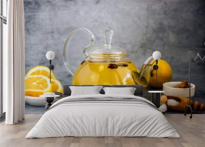 Spice fruit tea in a transparent teapot. Tea with pineapple, sea buckthorn, cinnamon, star anise, lemon and sugar Wall mural