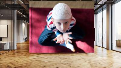 Muslim child inside mosque praying Wall mural