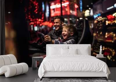 A joyful father and son having fun while playing a racing arcade game Wall mural