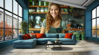 Cheerful young woman in a kitchen prepares various healthy dishes into green meal prep containers. The setting features a rustic, well-equipped kitchen. Wall mural