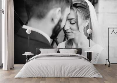 Close up portrait of wedding couple near old wrought iron gates. Black and white photo. Wall mural