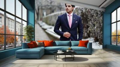 Elegant indian macho man model on suit and pink tie posed on winter day. Wall mural