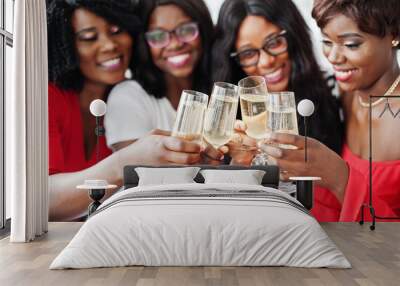 Group of partying african girls clinking glasses with sparkling wine champagne. Wall mural