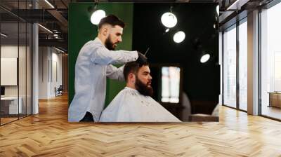 Handsome bearded man at the barbershop, barber at work. Wall mural