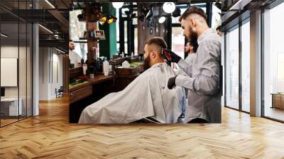 Handsome bearded man at the barbershop, barber at work. Wall mural