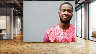 Portrait of a black young man wearing african traditional red colorful clothes. Wall mural