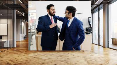 Two indian businessman in suits standing on cafe and discuss each other. Wall mural