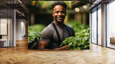 Young african american man working in a greenhouse, holding a bunch of lettuce. Generative AI. Wall mural