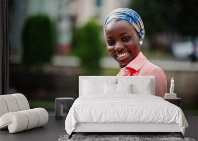 Young modern fashionable, attractive, tall and slim african muslim woman in hijab or turban head scarf posed. Wall mural