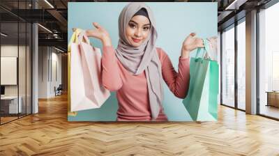 confident happy smiling muslim woman shopping. portrait of islamic customer woman hand holding shopp Wall mural