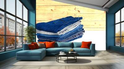  jeans stacked on wooden floor. blank background for design and text input. Wall mural