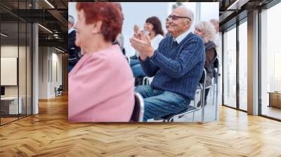 a group of senior citizens applaud in the conference room Wall mural