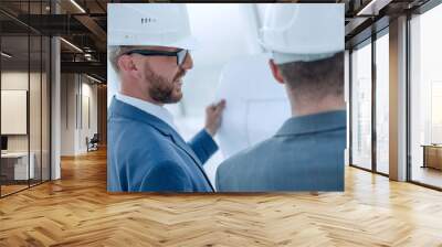 architect and engineer looking at blueprints of new project Wall mural