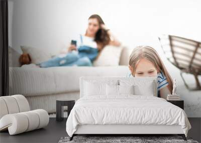 background image.mom and her daughter using their smartphones in their home Wall mural