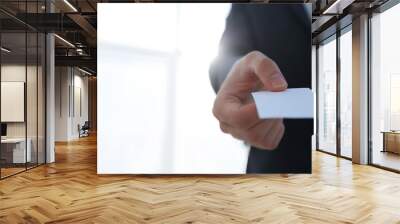 Business man giving business card on bright background Wall mural