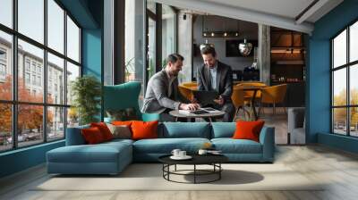 business men examining digital tablet in office area Wall mural